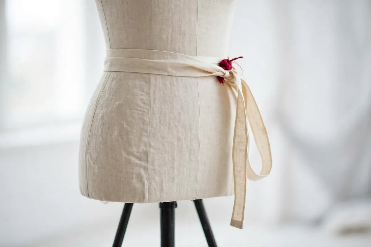 A dress form with a tape measure